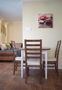 a dining room with a table and chairs and a couch at Sódomb vendégház in Egerszalók
