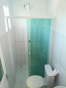 a bathroom with a toilet and a glass shower at Casa 70 Hostel 350m da praia Balneario Flamingo in Matinhos +17 photos