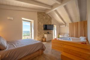 a bedroom with a bed and a bath tub at Valle in Fiore Suite - Private Jacuzzi & Sauna - ItalyWeGo in Ilci +35 photos