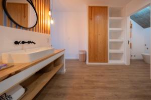 a bathroom with a sink and a mirror at Chez Nous I e II in Caloura +68 photos
