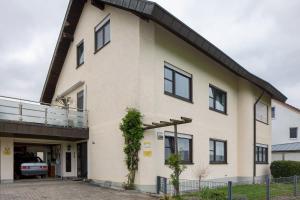 a building with a balcony on the side of it at Fewo Bella in Stegen