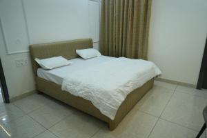 a bed with two pillows on it in a room at Hotel Griffin in Kīratpur