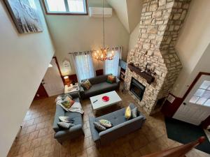 an overhead view of a living room with couches and a fireplace at Spa & Pool Table - L Experience in Petite-Rivière-Saint-François