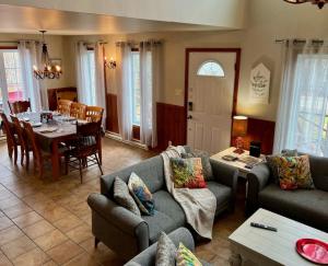 a living room with couches and a table and a dining room at Spa & Pool Table - L Experience in Petite-Rivière-Saint-François +36 photos