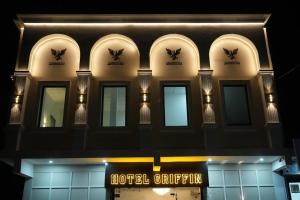 a building with a hotelstripination sign in front of it at Hotel Griffin in Kīratpur +13 photos