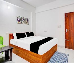 a bedroom with a large bed in a room at Shivam Elite Comforts in Bangalore