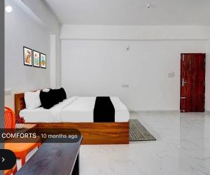 a bedroom with a large bed and a red door at Shivam Elite Comforts in Bangalore