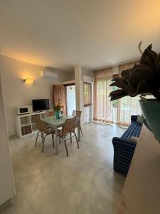 a living room with a table and chairs at Aviotel Residence in Marina di Campo