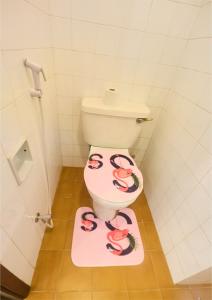 a bathroom with a toilet with snakes painted on it at Cutie Studio Unit Nyali in Mombasa