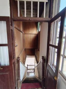 an overhead view of a staircase in an old building at Vikram homestay in Malvan