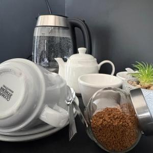 a table with a tea pot and a cup of coffee at Motel M69 in Leicester
