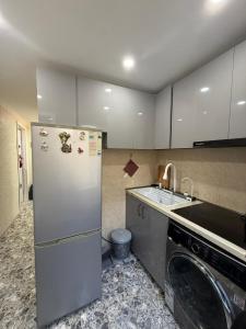 a kitchen with a stainless steel refrigerator and a sink at sofia guest house in Chiatʼura