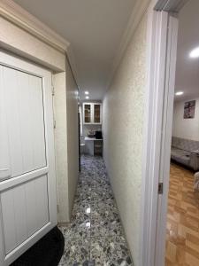 a hallway with a door leading to a room at sofia guest house in Chiatʼura
