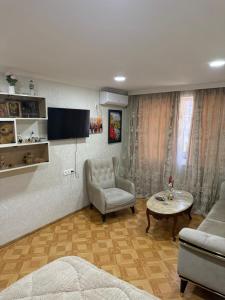 a living room with a couch and a chair and a table at sofia guest house in Chiatʼura