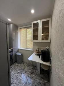 a kitchen with a white counter and a window at sofia guest house in Chiatʼura +4 photos