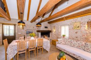 a dining room with a table and a couch at House Bilusic in Poljica