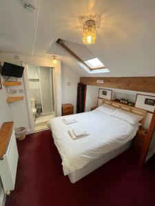 a bedroom with a large white bed with a window at Marston town centre villa in Blackpool