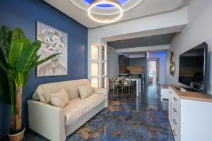 a living room with a couch and a dining room at Poseidon 5 in Paralia Katerinis