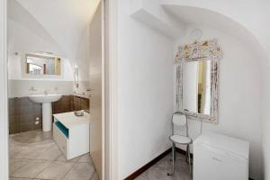 a white bathroom with a sink and a mirror at Al Castello Residenza D'Epoca in Pietra Ligure +50 photos
