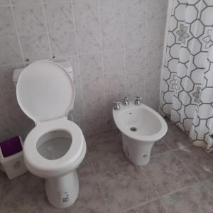 a bathroom with a toilet and a bidet at Complejo Enjoy in Las Grutas