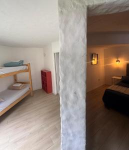 a room with two beds and a concrete pillar at Posada PuntaDelEste in Punta del Este