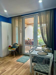 a living room with a table and a glass door at Kesane in Telavi