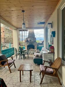 a living room with a patio with a fireplace at Kesane in Telavi