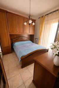 a bedroom with a bed with a wooden headboard at La Casa Serena in Scalea +33 photos