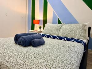 a bedroom with a bed with blue towels on it at The Skyline Luxury Unit in Bélanger