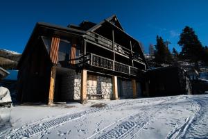 a house in the snow with footprints in the snow at Apartments Zvoh, Krvavec, Ski-in, Ski-out in Cerklje na Gorenjskem +30 photos