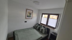 a small bedroom with a bed and a window at Mitten im Sauerland in Finnentrop