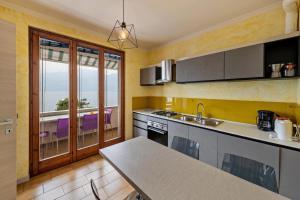 a kitchen with a sink and a counter top at Casa Tuly 1 in Brenzone sul Garda