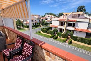 a balcony with two chairs and a view of houses at La Casa Serena in Scalea