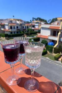 three wine glasses sitting on top of a table at La Casa Serena in Scalea
