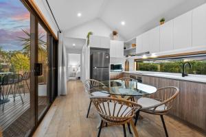 a kitchen with a glass table and chairs at Three Ponds Estate in Temora