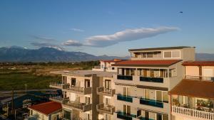 a view of a building with mountains in the background at Poseidon 5 in Paralia Katerinis