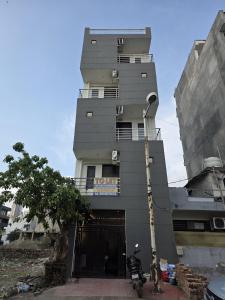 a tall building with a motorcycle parked in front of it at The Cozy Nest in Gurgaon