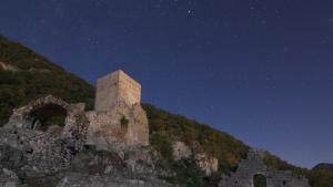 a building on top of a mountain at night at logis des comtes in Bramevaque