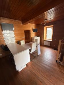 a room with a white table and chairs in it at logis des comtes in Bramevaque