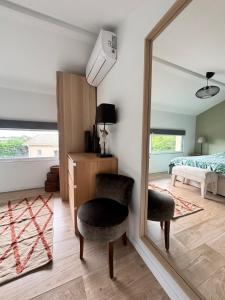 a mirror in a room with a bedroom and a bed at Maison proche Hossegor in Tosse