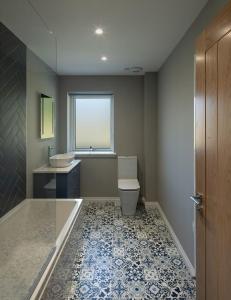 a bathroom with a toilet and a sink and a window at Sunny Ridge in Fort Augustus +15 photos