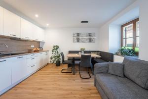a kitchen and living room with a table and a couch at Wohnung Morgenduft Schnalserhof in Laces