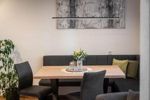 a dining room with a wooden table and chairs at Wohnung Morgenduft Schnalserhof in Laces +13 photos