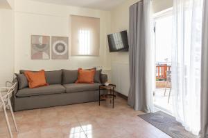 a living room with a couch and a window at Sunset Cove by halu! - Spacious 4-bedroom Villa in Neos Marmaras