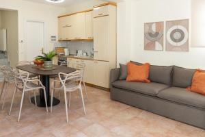 a living room with a couch and a table at Sunset Cove by halu! - Spacious 4-bedroom Villa in Neos Marmaras