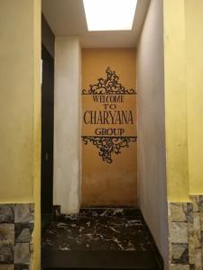 a hallway with a sign on the wall of a building at Charyana Heights Ac Dormitory in Ahmedabad +4 photos