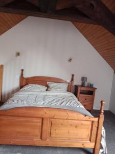 a bedroom with a wooden bed and a wooden dresser at Maison au bord de l'Erdre in La Chapelle-sur-Erdre