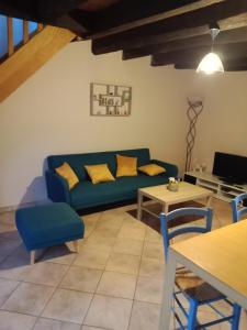 a living room with a couch and a table at Maison au bord de l'Erdre in La Chapelle-sur-Erdre