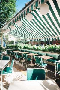 an outdoor seating area with tables and chairs under an umbrella at CasaSur Bellini in Buenos Aires