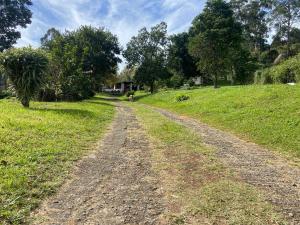 a dirt road in the middle of a field at Mountain View Escape in Mbabane